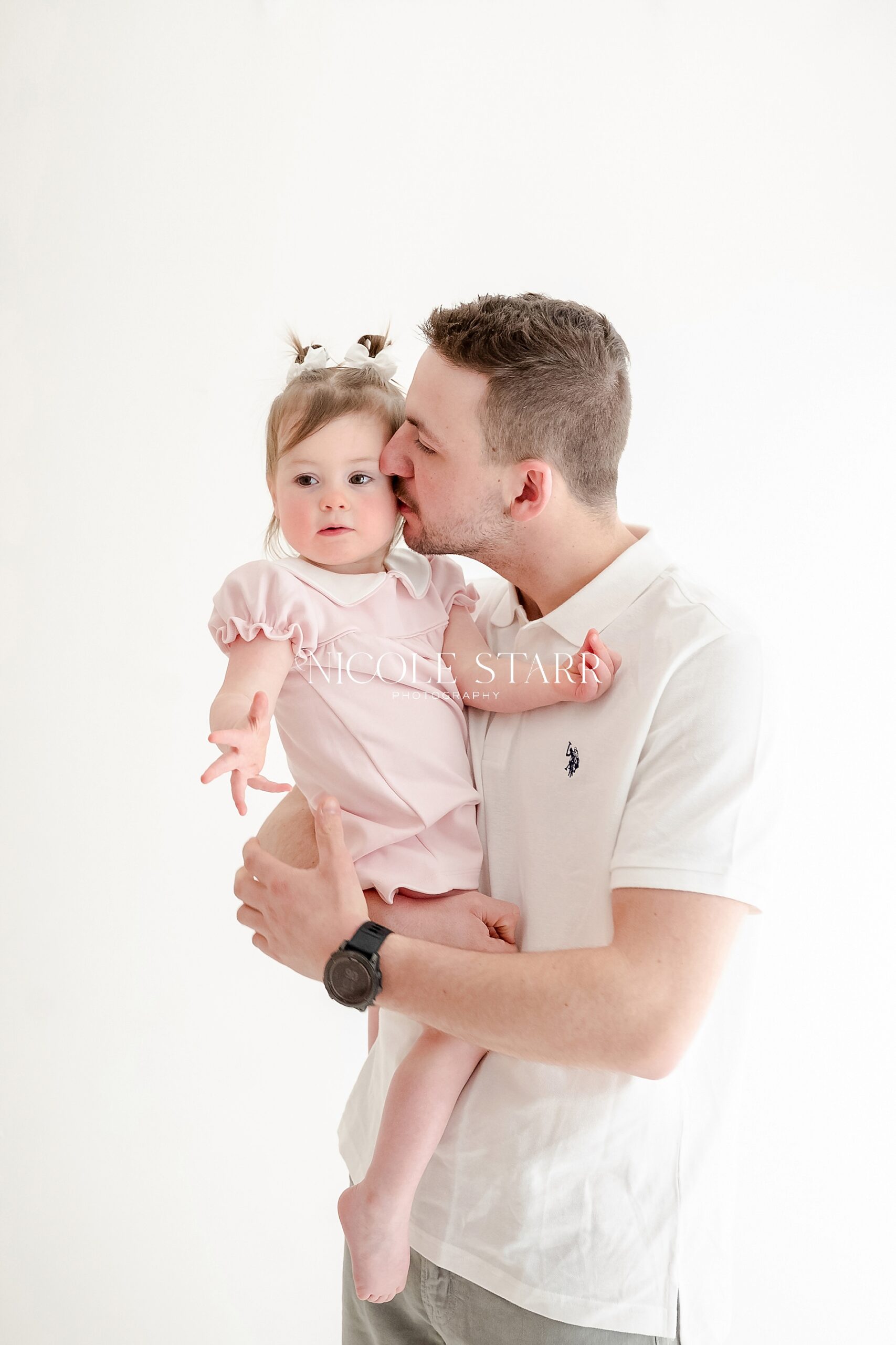 dad kisses daughter's cheek