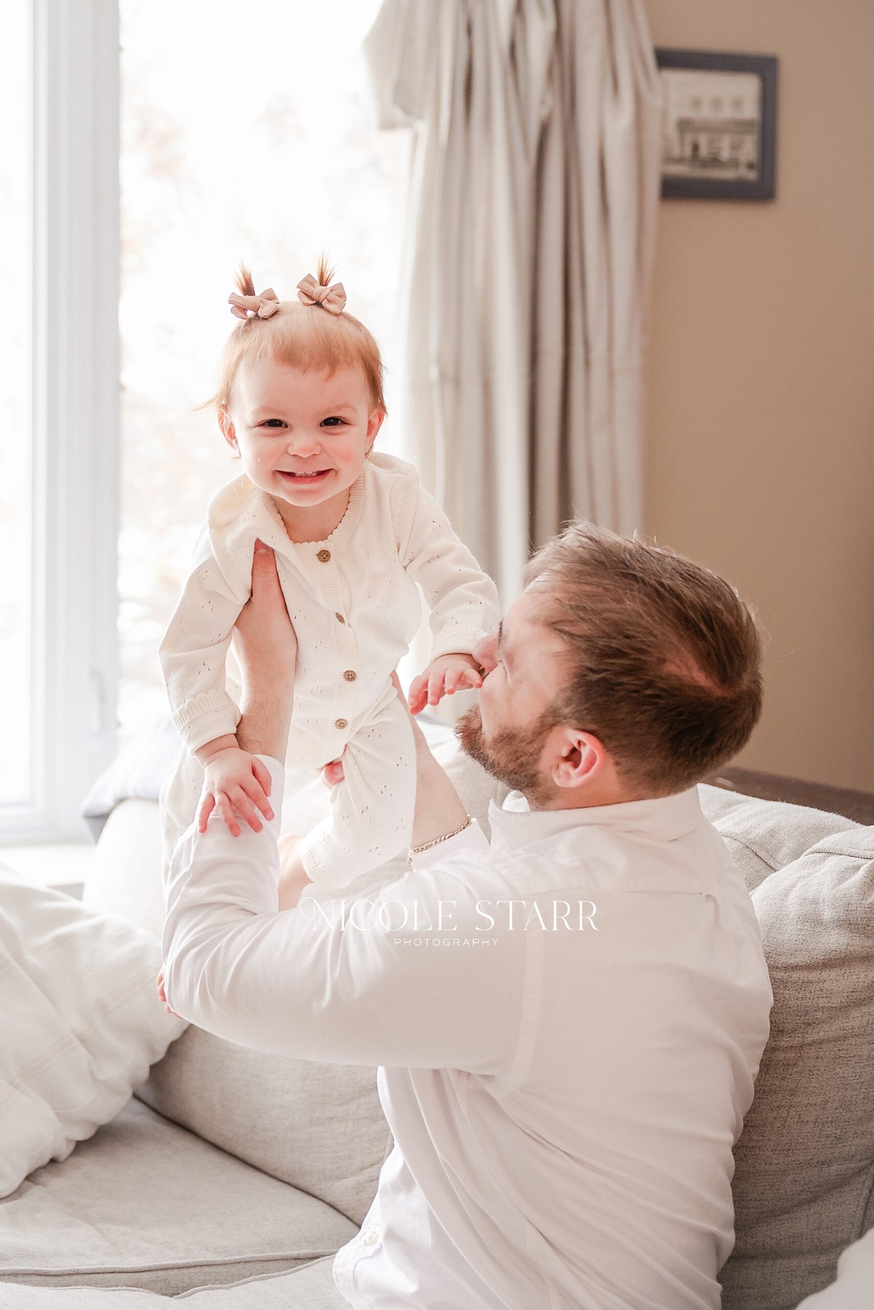 dad holds up toddler
