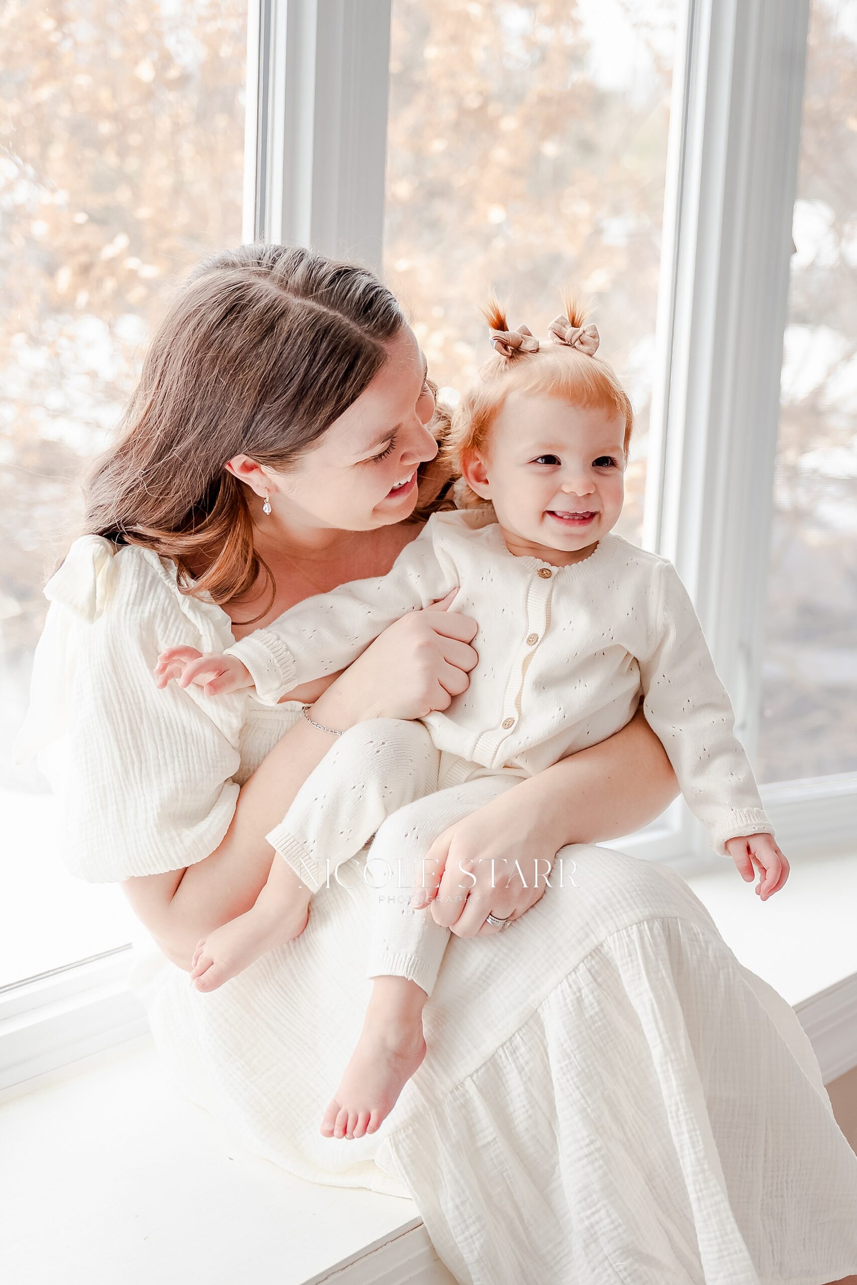 mom sits with toddler during in-home lifestyle session