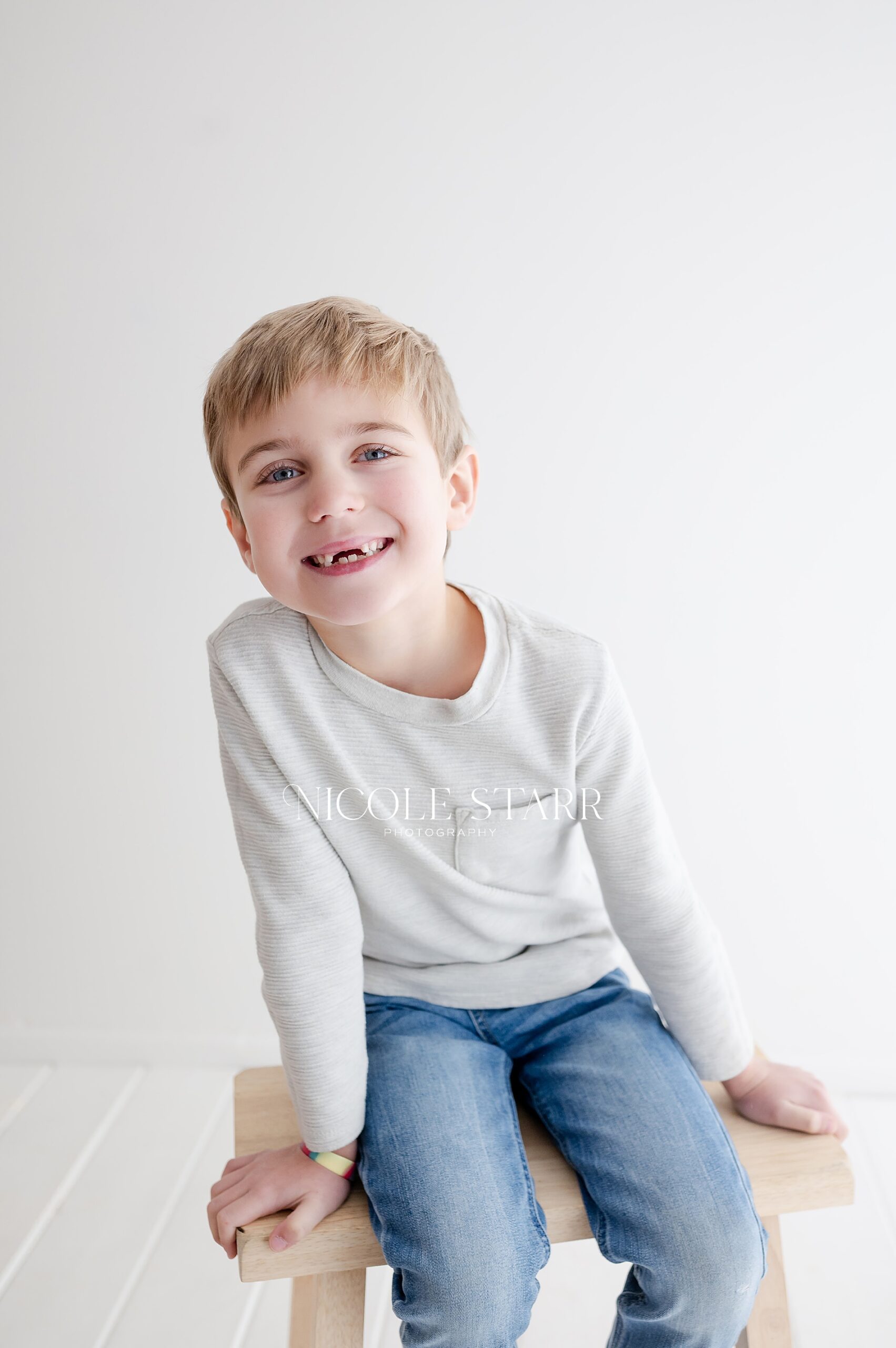 little boy in neutral clothes