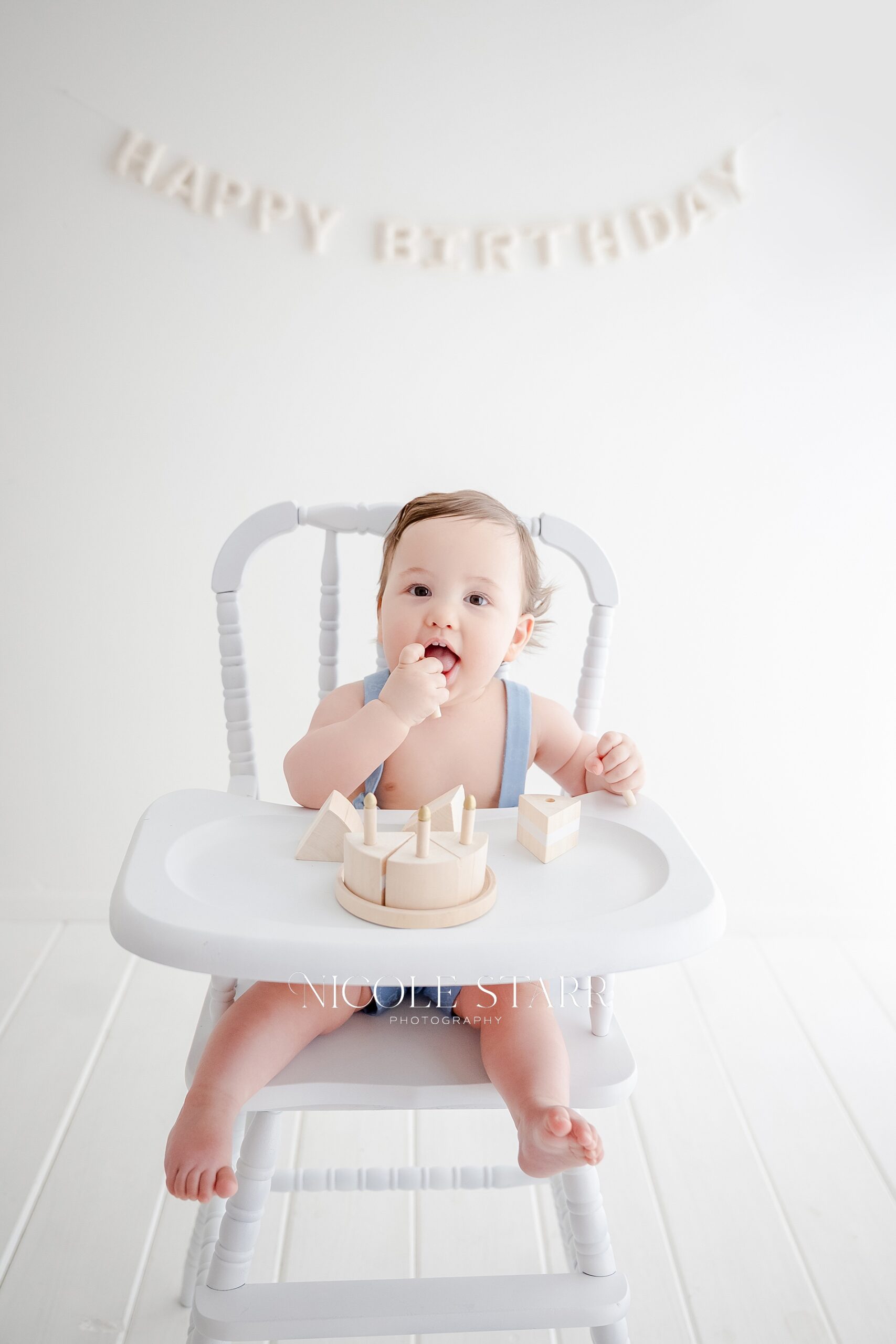 baby sits in high chair at Saratoga Springs studio for first birthday portraits