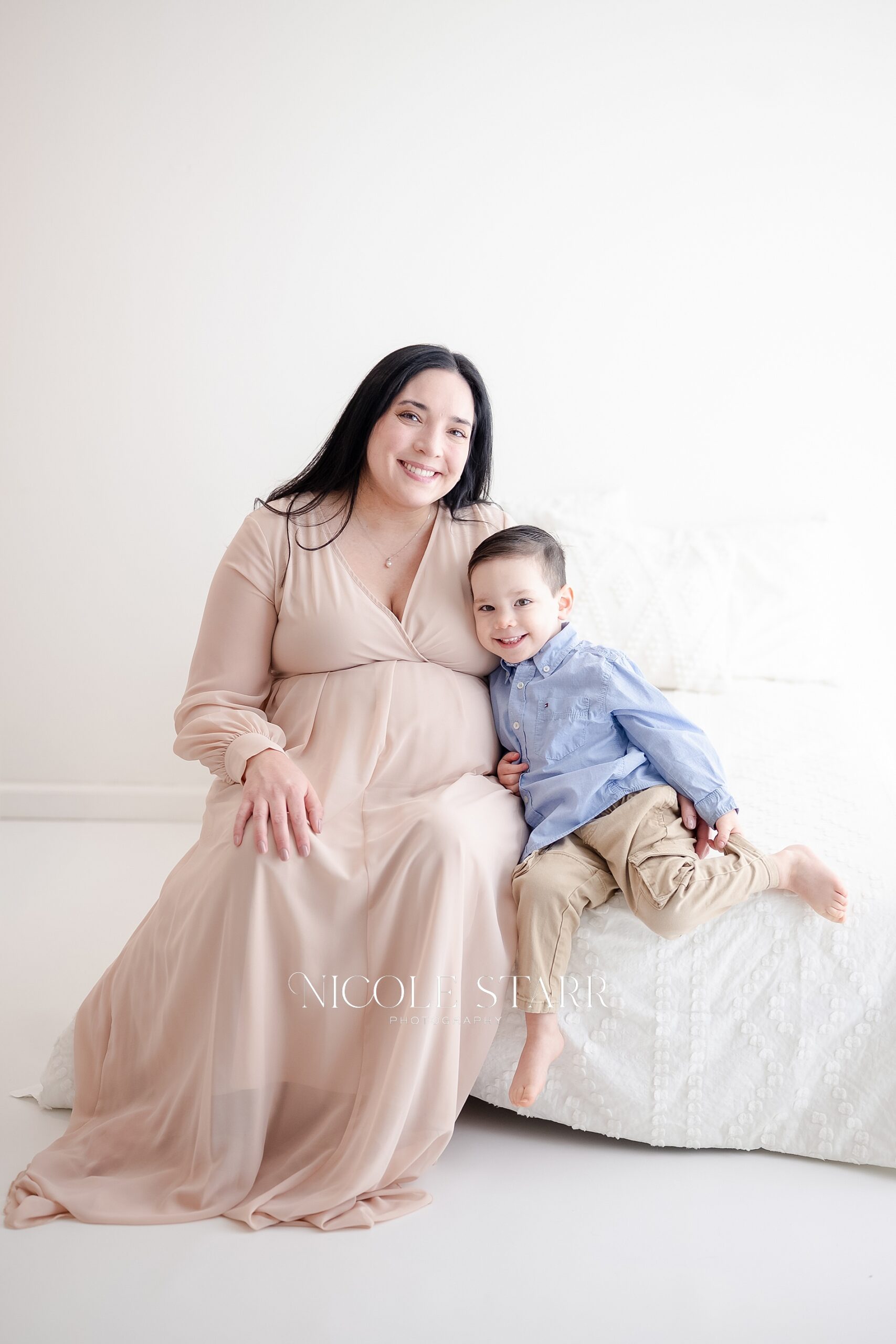 expectant mom sits with her son