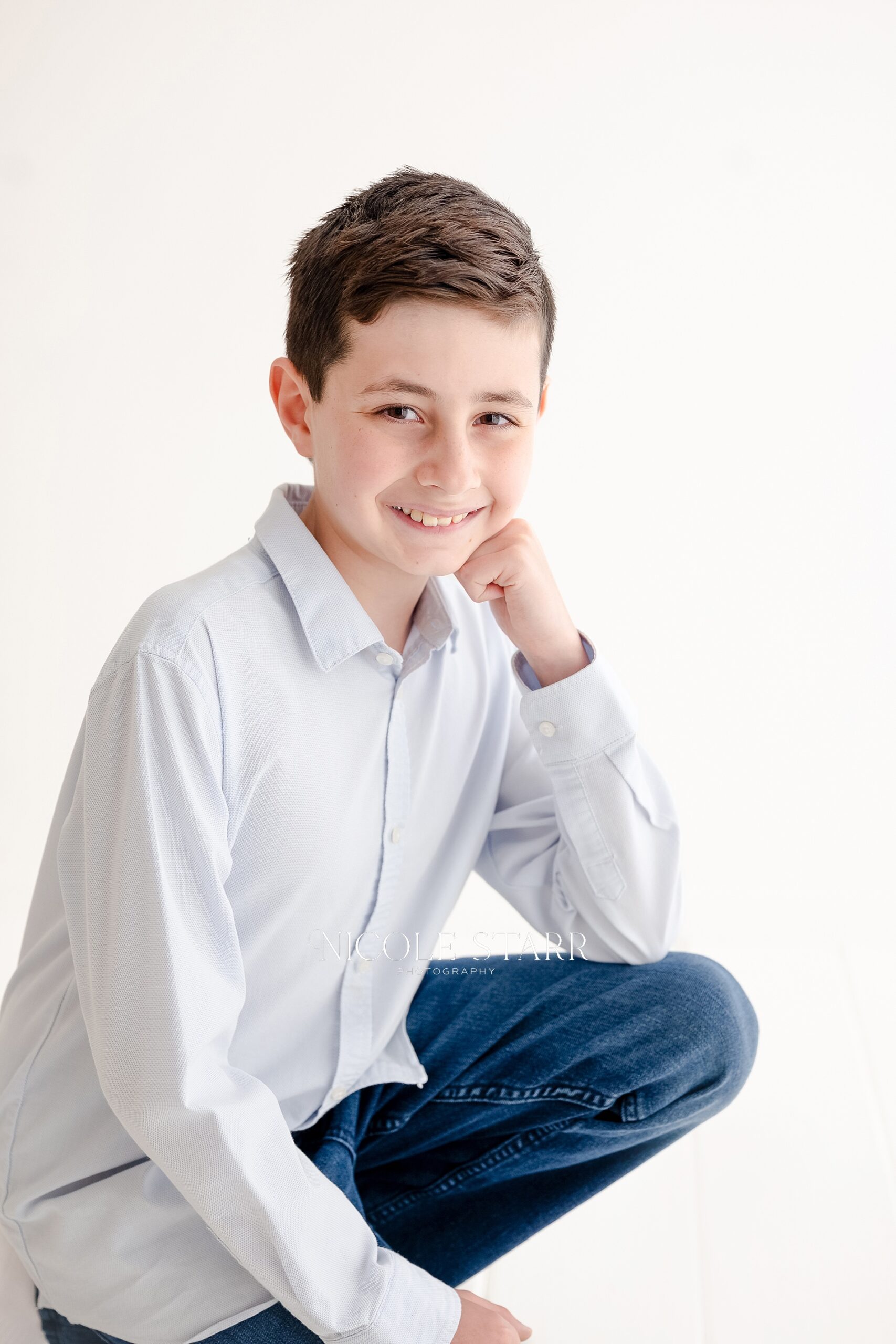 big kid kneels down for child portraits in Saratoga Springs Studio