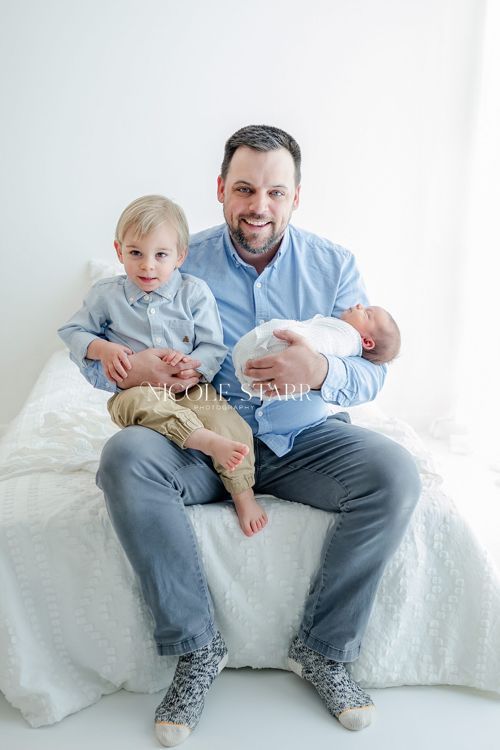 dad with two sons during newborn session