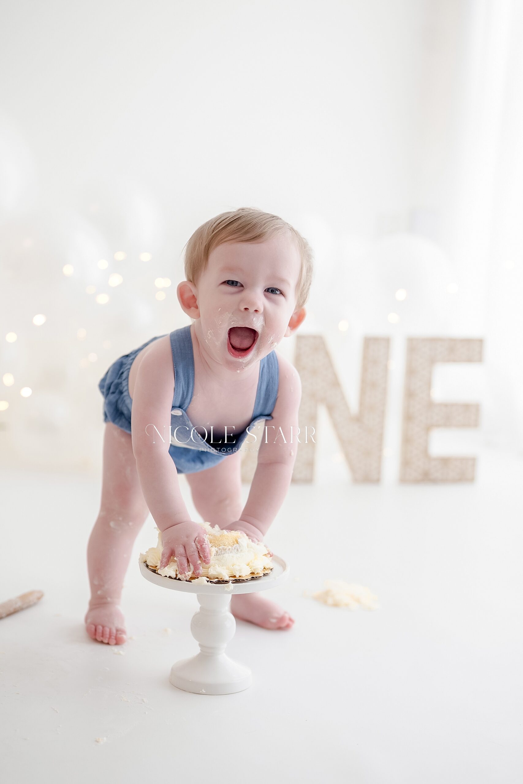 joyful one year old during cake smash