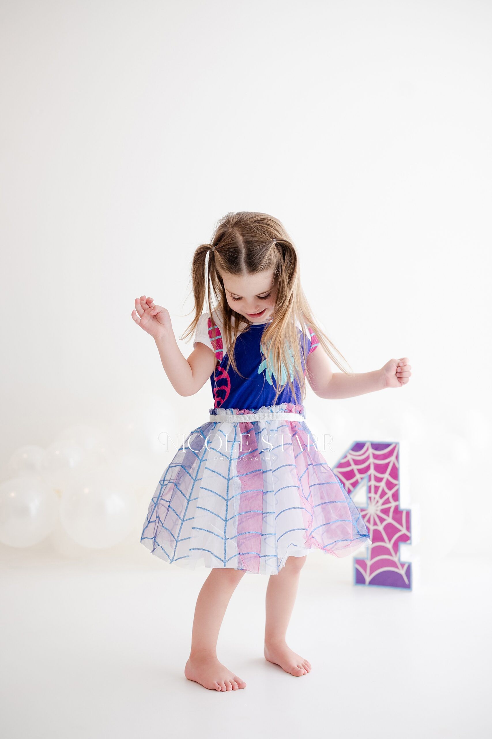 little girl dances in studio during milestone session