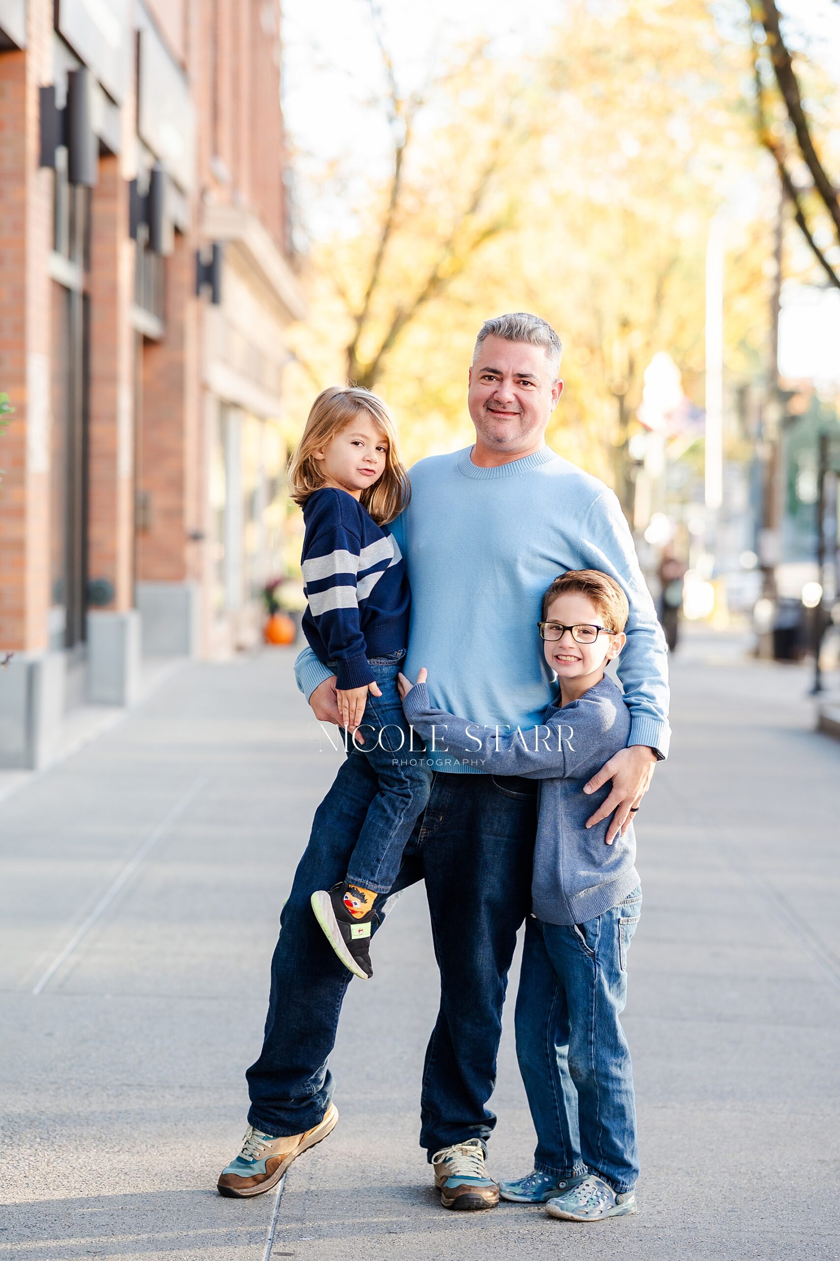 dad with his two children during Fall family portraits on Broadway in Saratoga Springs, NY