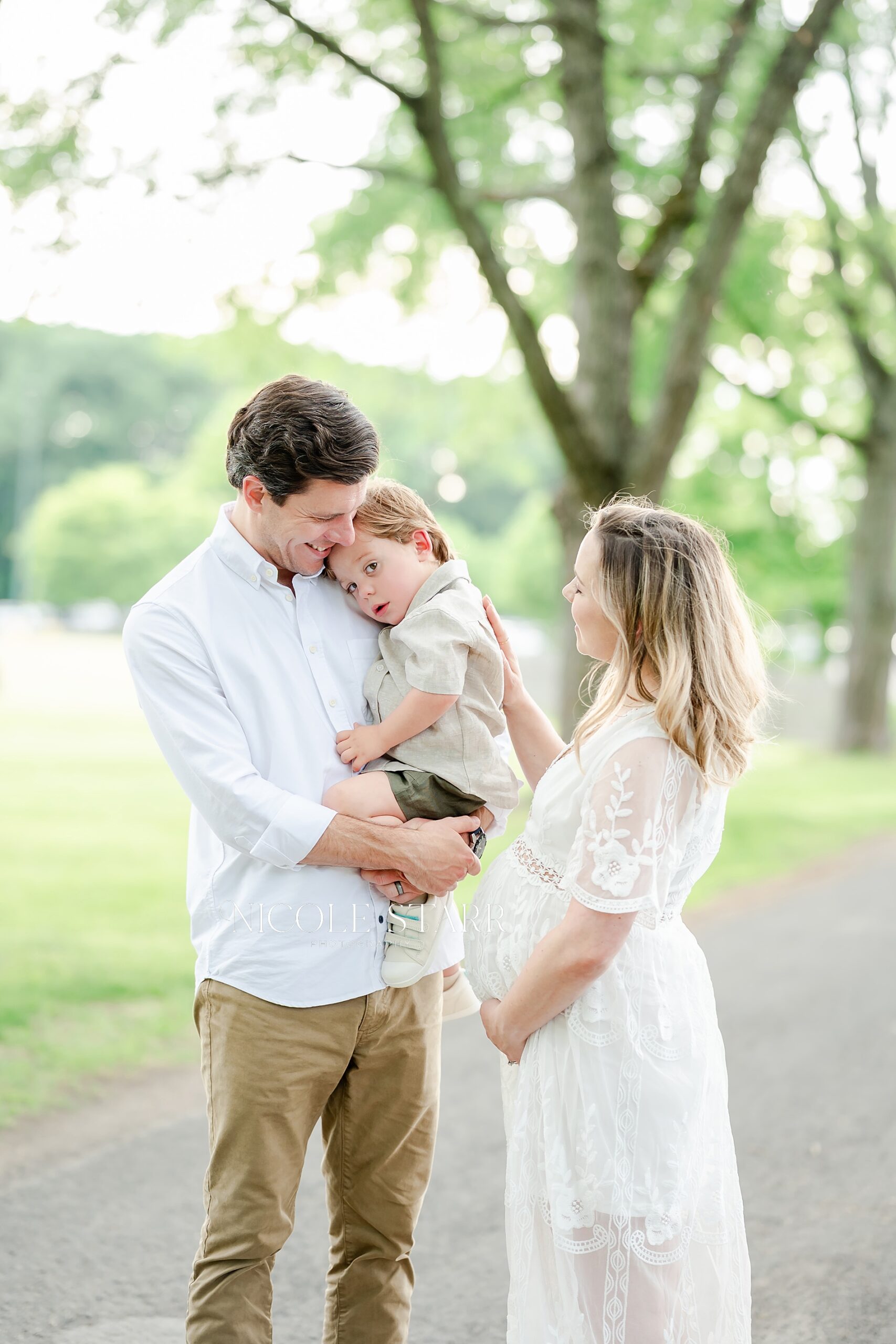 expectant parents with their first born son during maternity session