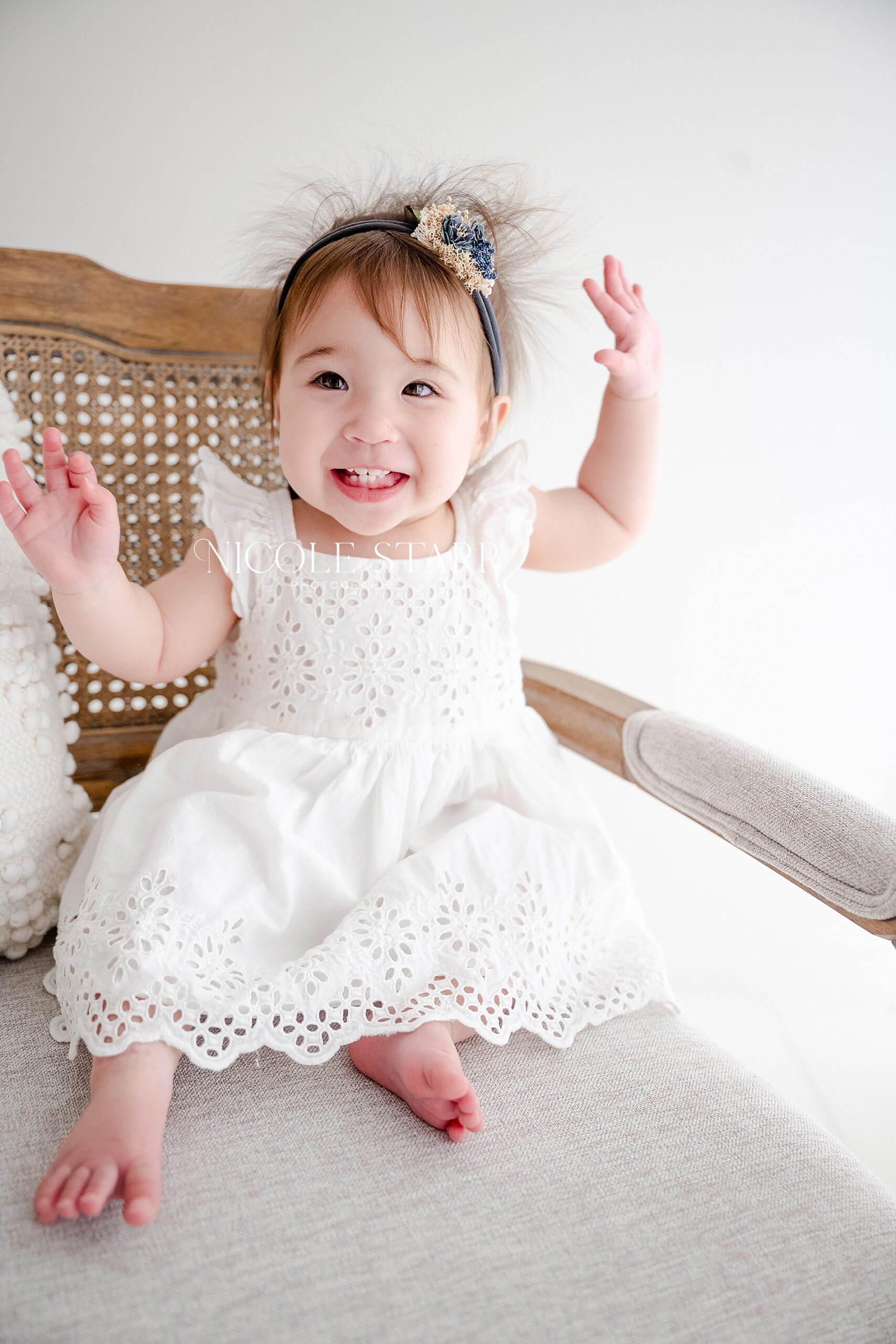 one year old girl in white dress for one year milestone session