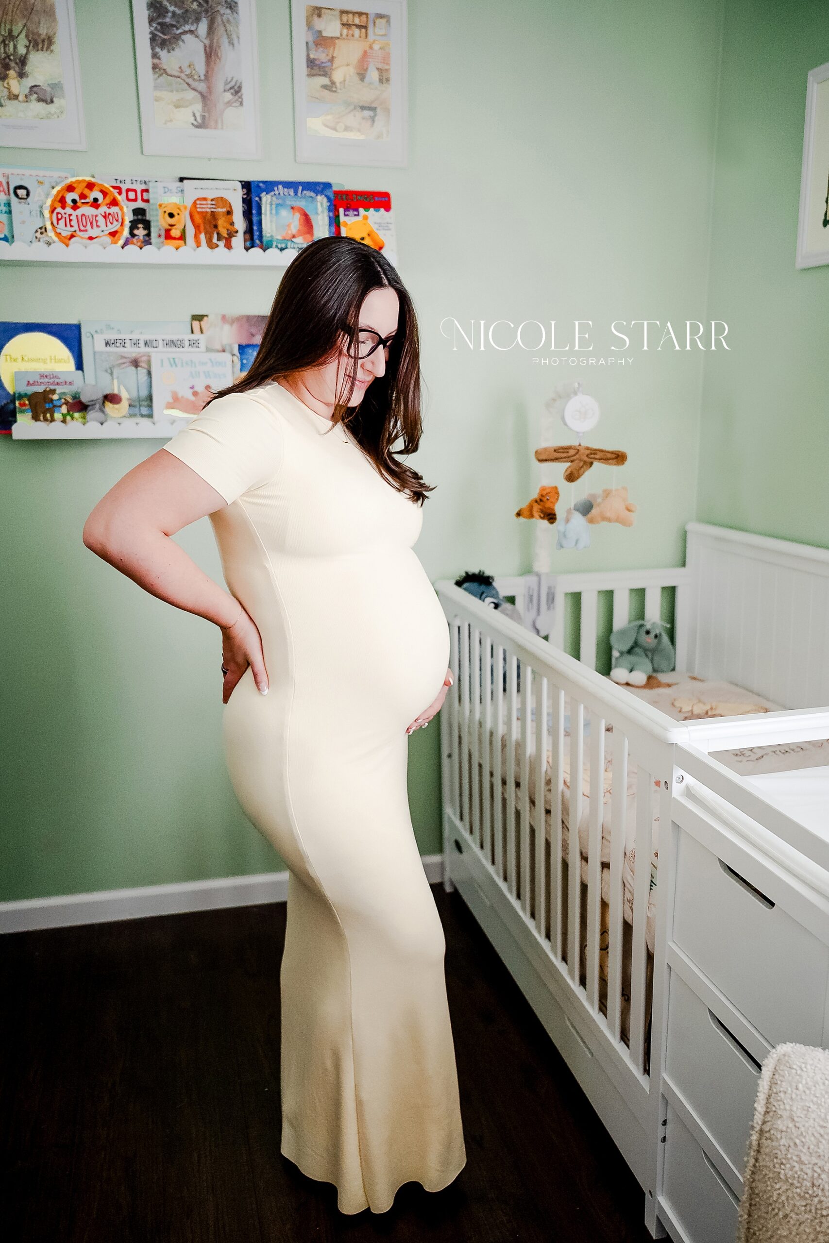 expectant mom in baby's nursery