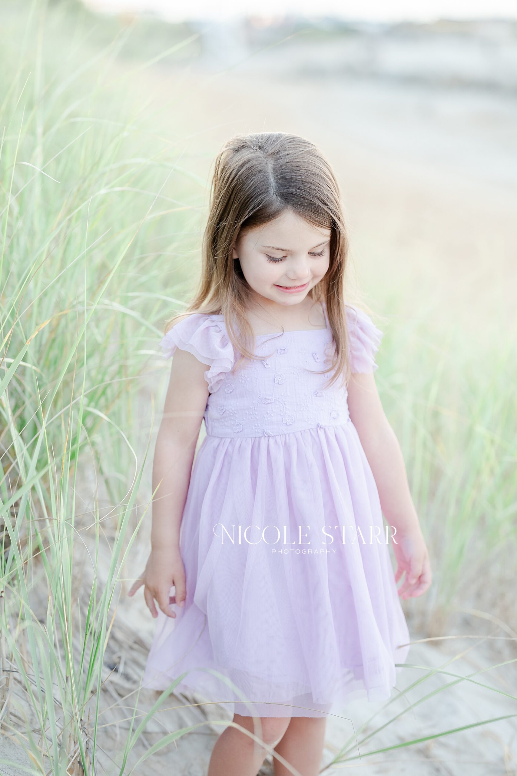 little girl in pink dress during Annual Beach Portraits on Cape Cod